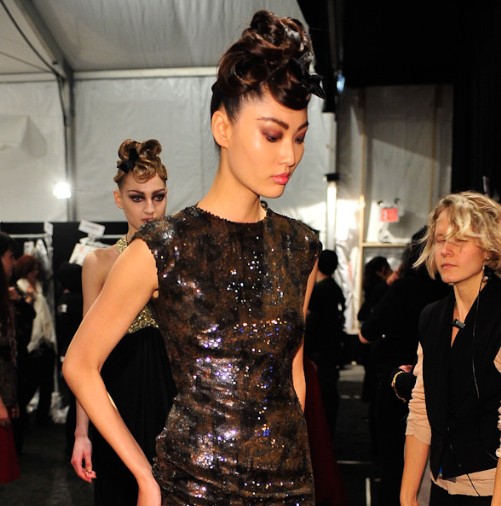 Model wearing Monique Lhuillier preparing to walk the runway at the Monique LHuillier Fall 2011 Collection Runway Show during Mercedes Benz Fashion Week.  Photographed by Arun Nevader