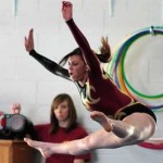 Nicole Mouser Competing in the Floor Exercise at a Gymnastic Meet at Wilson H.S. (Photo by Arun Nevader)