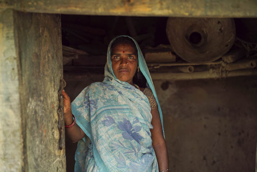 A farm worker from India's Ravidas community at Ganjtola, Sanita Das, uses the first toilet ever in her village, put there as part of a PSI pilot program helping to build 16,000 toilets. Men would sometimes throw stones at her and other women when they would relieve themselves in the field and says she'd rather be paid with a toilet than rupees, though she currently labors in exchange for rice.