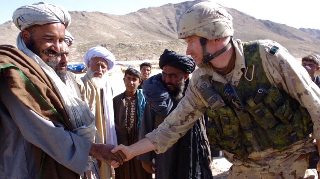 EMBARGOED ---- EMBARGOED ----- DO NOT USE UNTIL NAME OF OFFICER INJURED IS OFFICIALLY RELEASED ---- EMBARGOED.......leader engagement - 03/02/06 - NORTH OF KANDAHAR, AFGHANISTAN - Lt. Trevor Green says goodbye to a village elder following a leader's engagement. Green was attacked 2 days after this photo was taken, in a different village, but during a similar leader's engagement with village elders. He sustained a head injury when he was hit with an axe. Troops shot and killed the attacker immediately after the attack. (Rick Madonik/Toronto Star) (DIGITAL IMAGE) rm